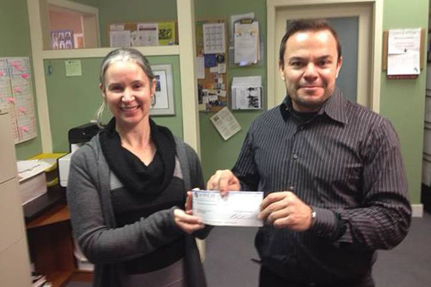 Vancouver Island Real Estate Board past president Jason Finlayson presents a cheque to Cowichan Intercultural Society executive director Lynn Weaver on Jan. 5.