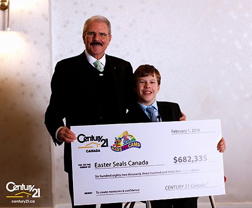 Century 21 Canada founder U. Gary Charlwood presents a cheque worth $682,335 to Easter Seals National Ambassador Brandon Liston.