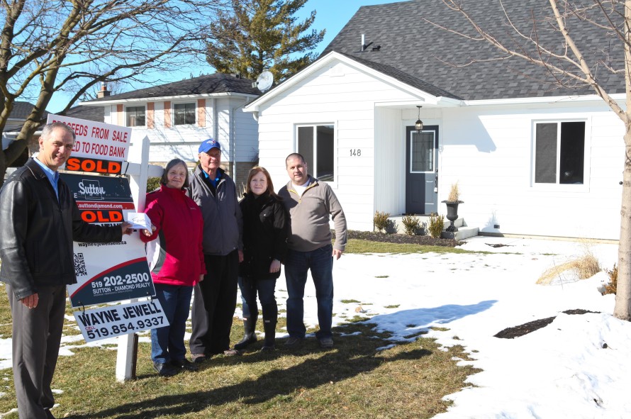 Pictured above (left to right): Wayne Jewell, Jean and Bob Davis, and Michelle and Jamie Rice in front of their Queen Street home.