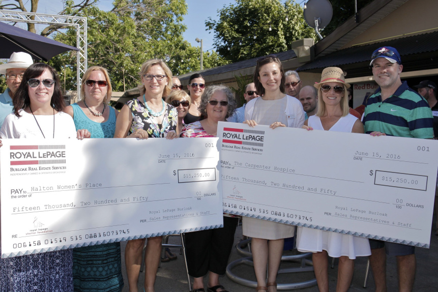 Rebecca Ryder, Brenda Macdonald, Janice Hamilton of Halton Women's Place, Angie Mackie, Gloria Vidovich of Carpenter Hospice, JoAnn Landry and Rob Landry, all of Royal LePage Burloak, pose for a photo during the cheque presentation at the Royal LePage Burloak's annual BBQ. Photo by Noah Park, special to Metroland Media Group.